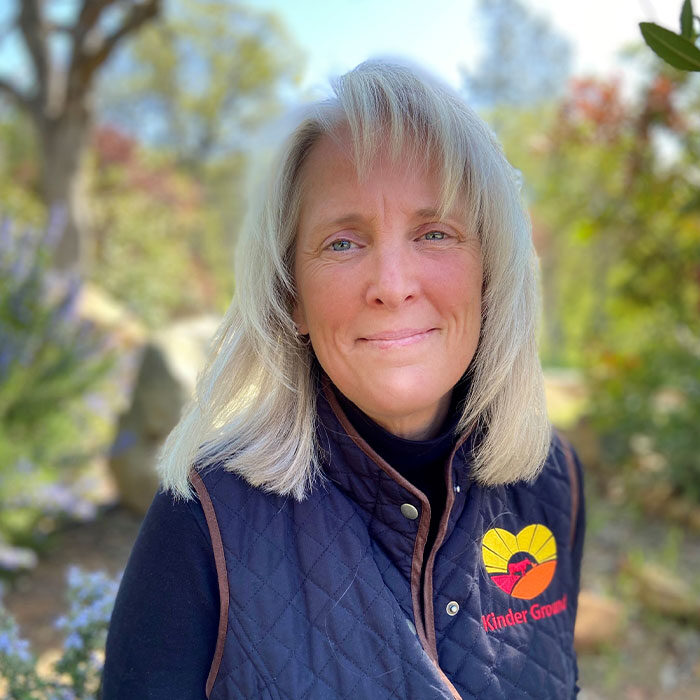 A photo of Cr. Jen Walker wearing a Kinder Ground vest.