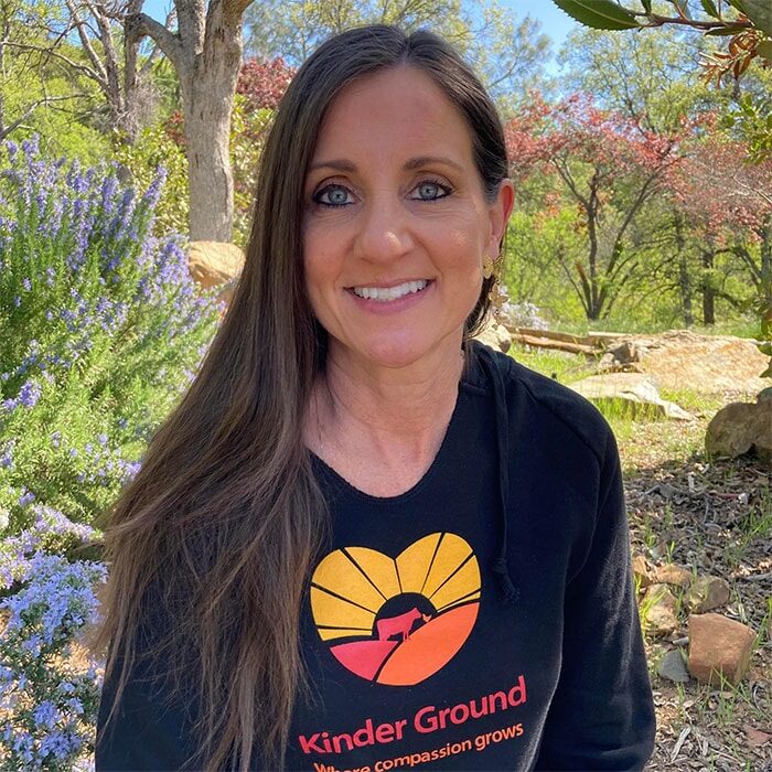 A photo of Lisa Cranfill wearing a Kinder Ground t-shirt.